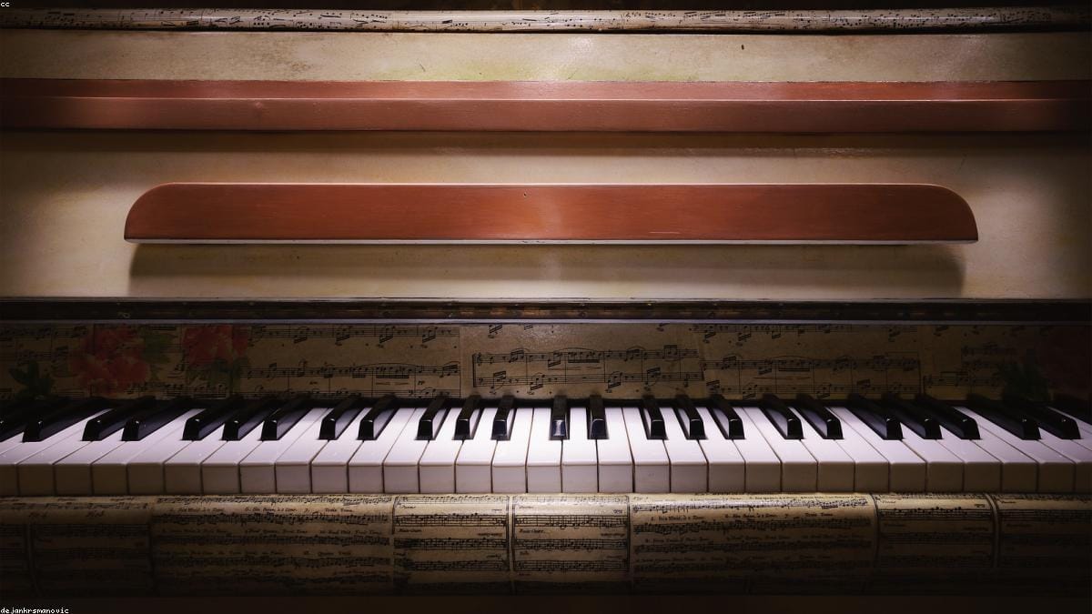 An adult learning to play piano at home